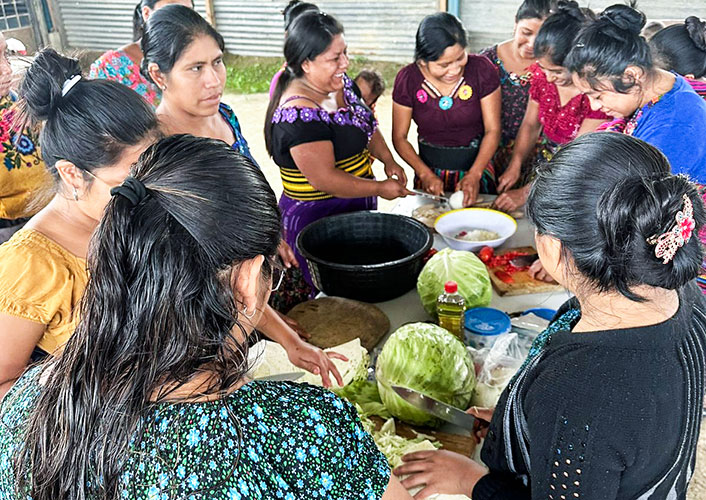 A group of women engaged in food preparation.
